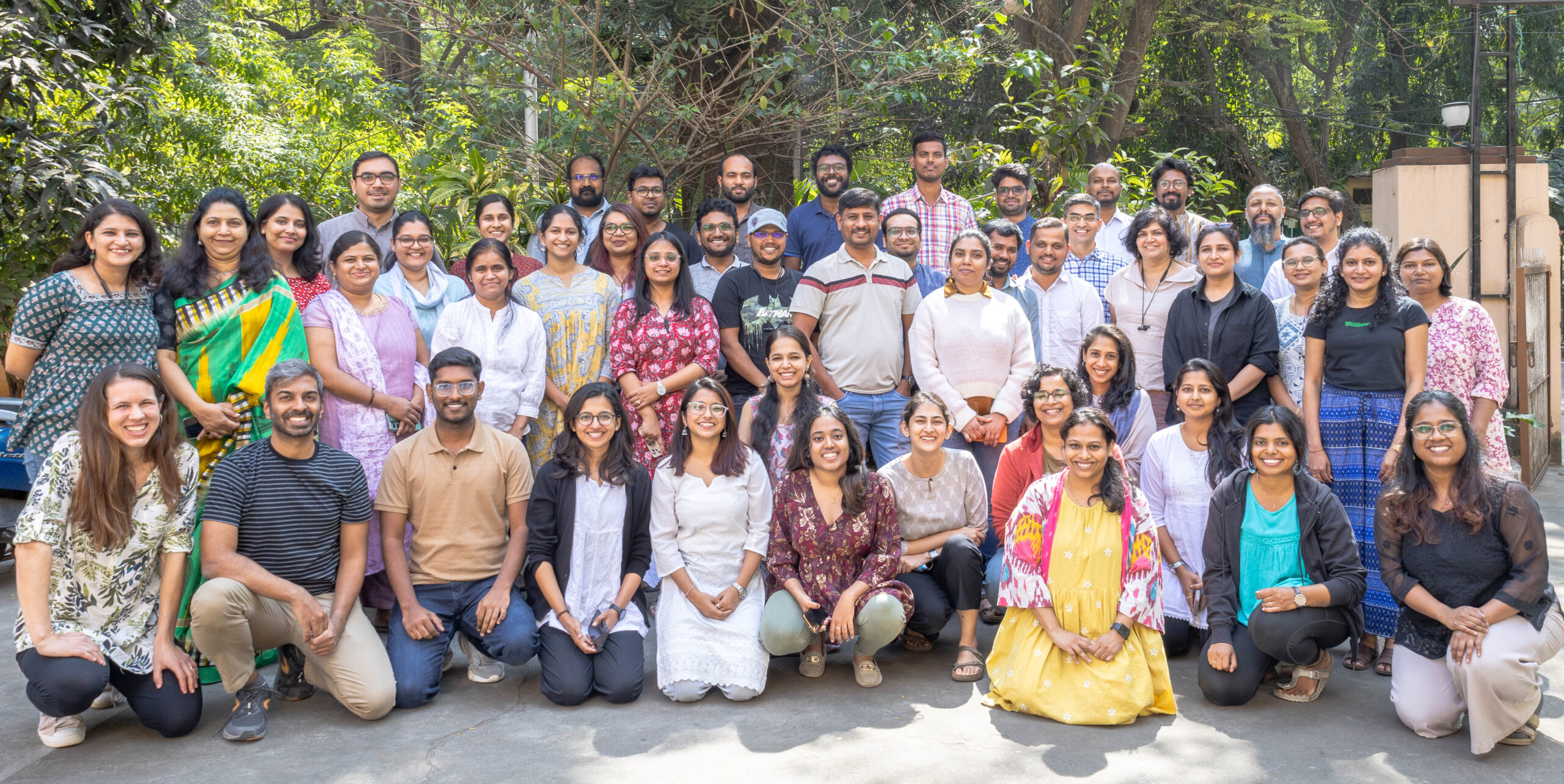 Image of about 60 people, all employees of WELL Labs, posing for the camera in a group.